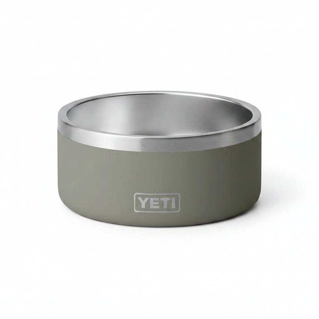 A YETI insulated pet bowl with a matte sage green exterior and a brushed stainless steel interior, shown on a clean white background.