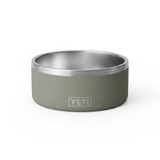 A YETI pet bowl with a matte sage green exterior and a brushed stainless steel interior, featuring the embossed YETI logo on the front.