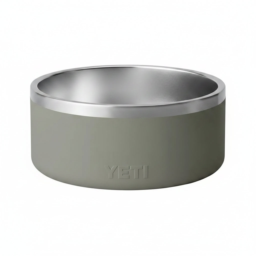 A YETI pet bowl with a matte sage green exterior and a polished stainless steel interior, shown on a clean white background.