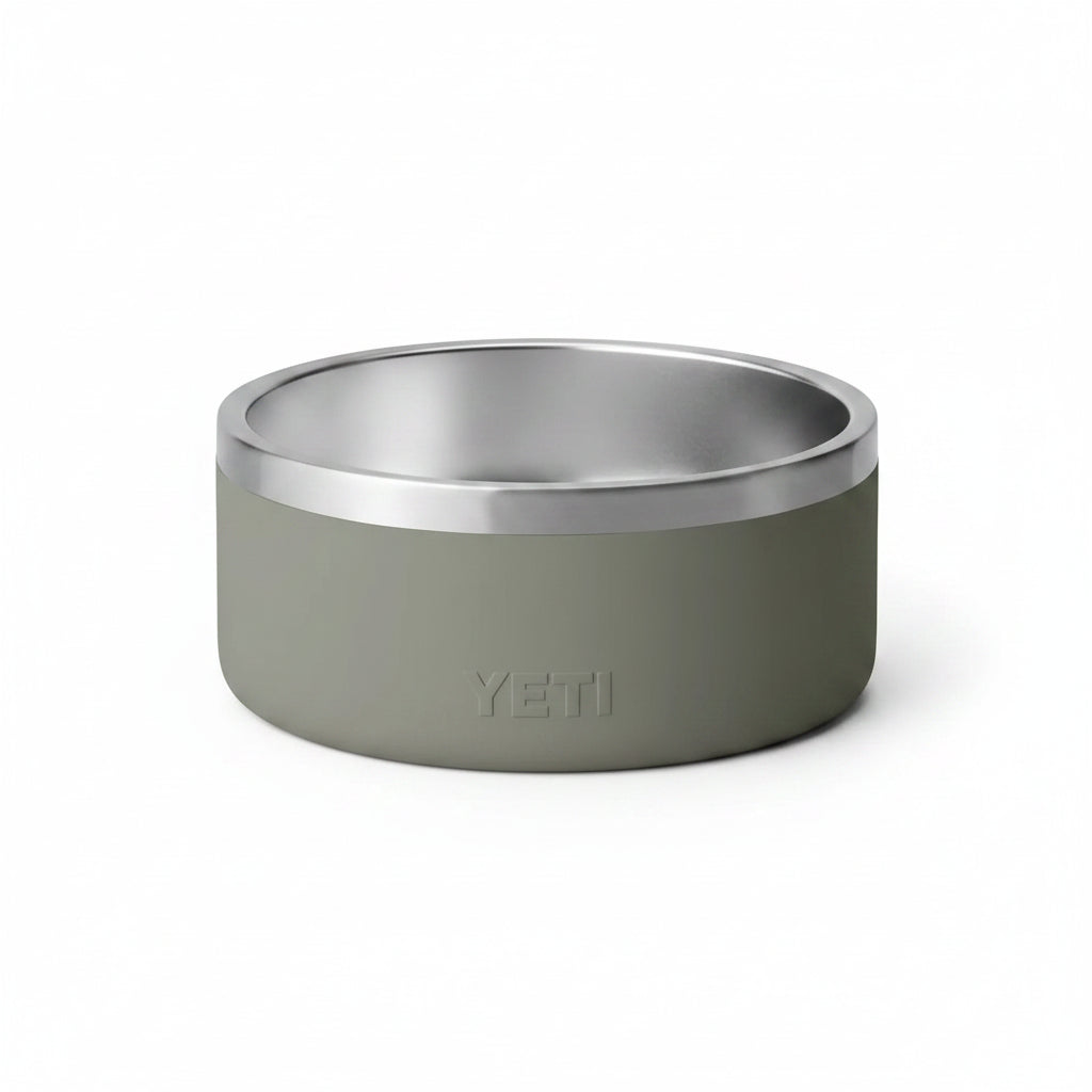 A YETI insulated pet bowl with a matte sage green exterior and a brushed stainless steel interior, shown on a clean white background.