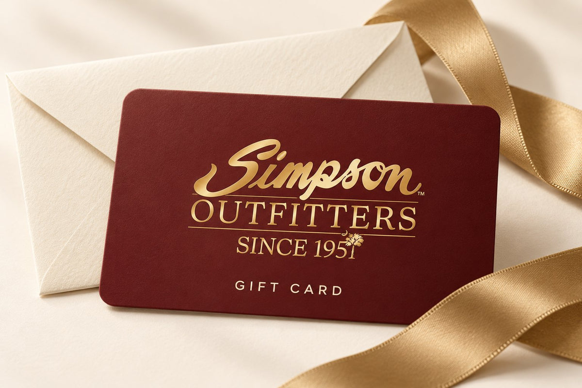Simpson Outfitters gift card in burgundy and gold on a cream envelope with a gold ribbon